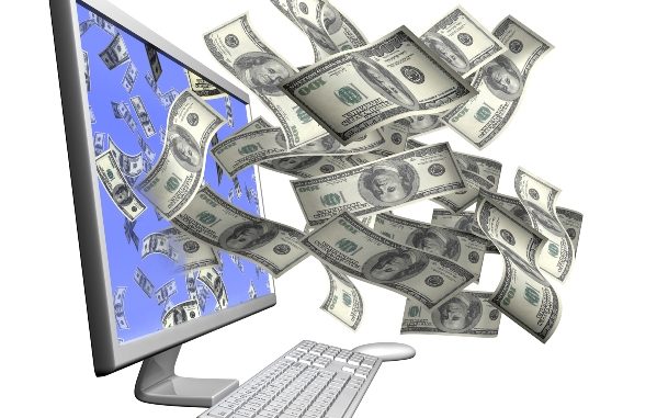 Isolated desktop computer throwing out hundred dollar bills through the screen